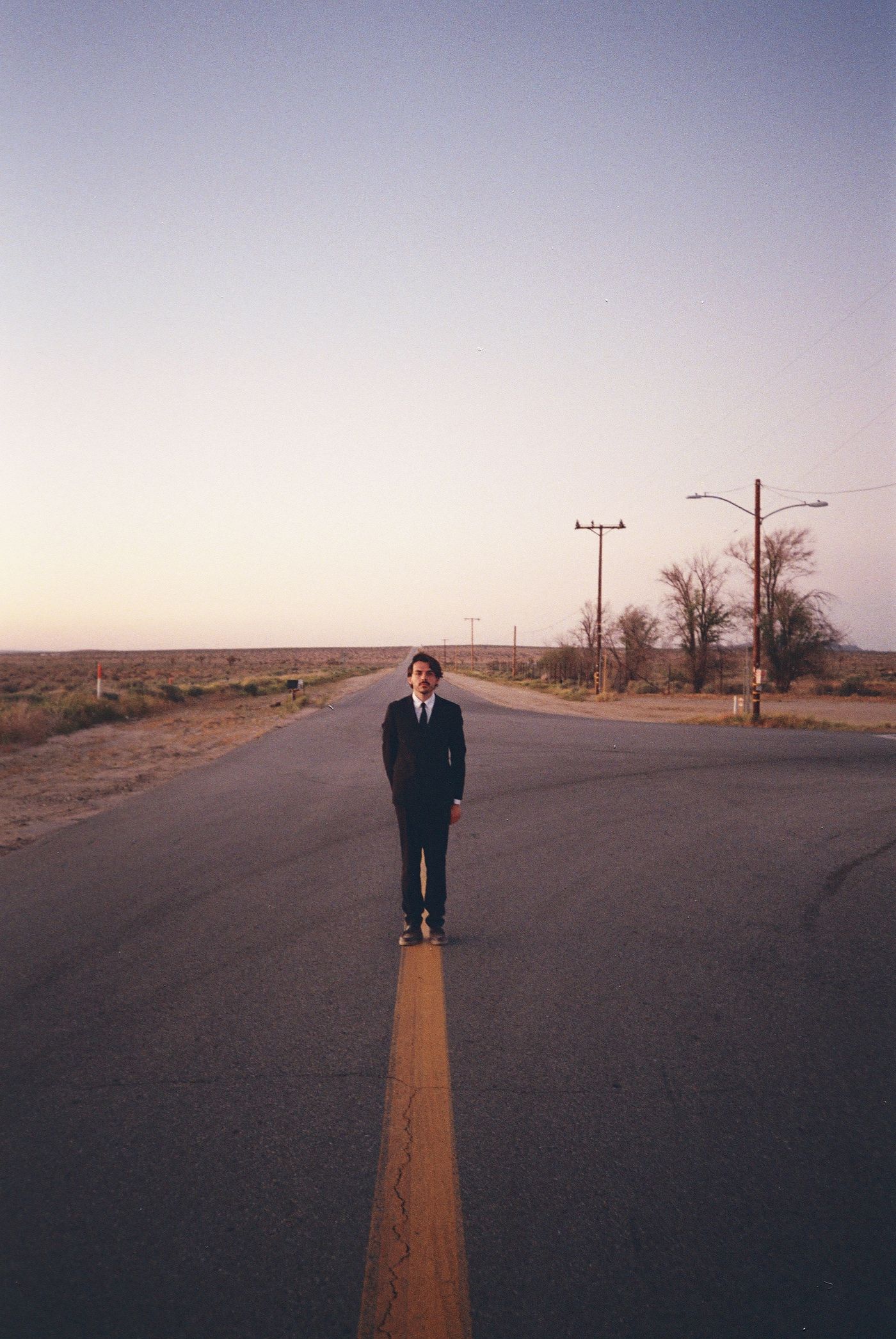 Guillaume Banet standing on the yellow line of an empty desert road